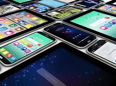 Multiple smartphones and tablets displaying various app interfaces on their screens